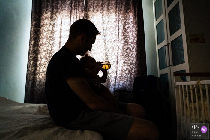 Dusseldorf documentary family photography of a Father giving his baby daughter tea