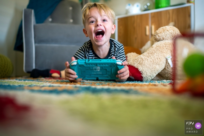 Phoenix family photography of a boy playing a video game and Leveling up