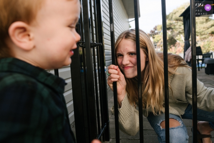 Photo by: <a href="https://www.fpja.com/documentary-family-photography-contests/viara-mileva/kingston/2115330">Viara Mileva - Canada</a> A Kingston, Canada family photographer captured a Little boy playing with a family friend