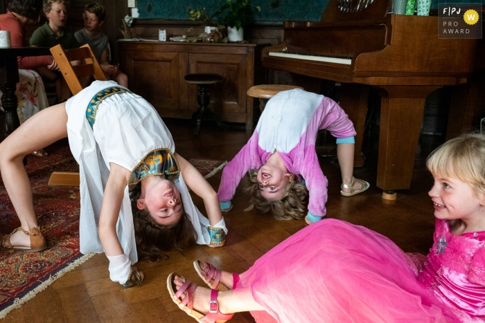 A Flanders family photographer captured this backbend arch bridge gymnastic session at home