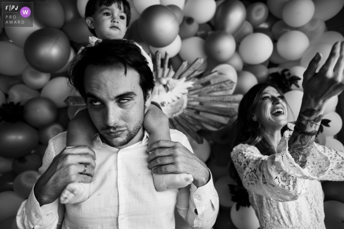 A Ribeirao Preto documentary family photographer chronicled this moment at a party for the child baptized