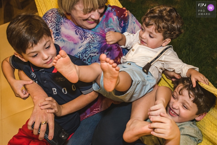 Campo Grande family documentary photography session with kids caught up In the mess with grandma