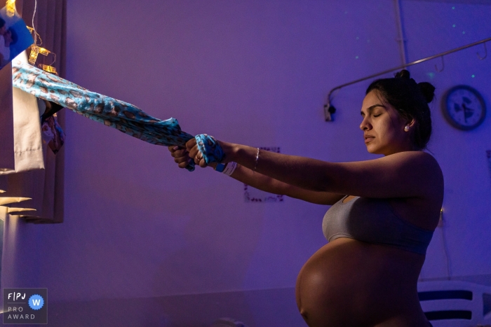 Rio de Janeiro birth documentary photography showing a Connection for the mother as she enters a contraction Rio de Janeiro birth documentary photography showing a Connection for the mother as she enters a contraction