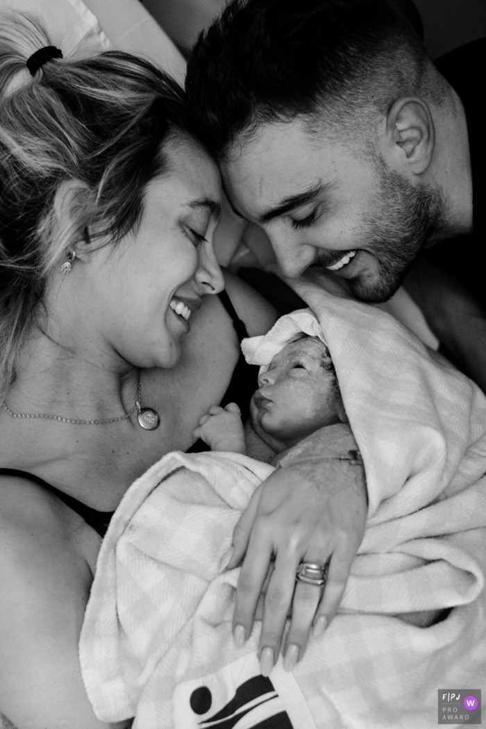 Award winning Florianopolis birth photography at Ilha Hospital of Maternidade capturing the Looks of parents and child on the day of birth Award winning Florianopolis birth photography at Ilha Hospital of Maternidade capturing the Looks of parents and child on the day of birth