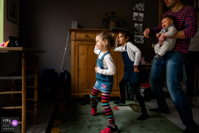 Wallonie, Belgium best documentary family picture from a home session showing what a just dance family looks like while playing together and getting exercise Wallonie, Belgium best documentary family picture from a home session showing what a just dance family looks like while playing together and getting exercise