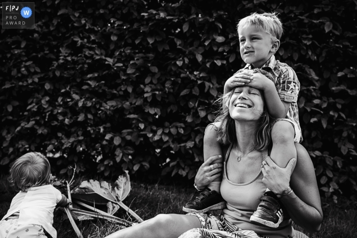 Documentary family photojournalism from Belgium showing the happy mom with her kids Documentary family photojournalism from Belgium showing the happy mom with her kids
