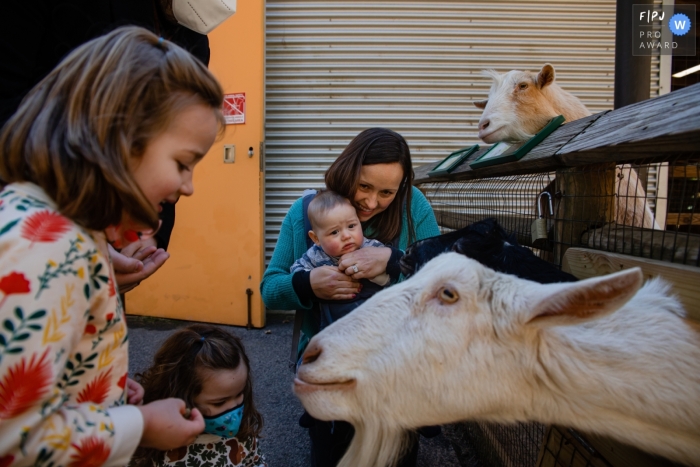 Georgia daughters are Feeding the Goats during an Atlanta documentary family photography shoot Georgia daughters are Feeding the Goats during an Atlanta documentary family photography shoot
