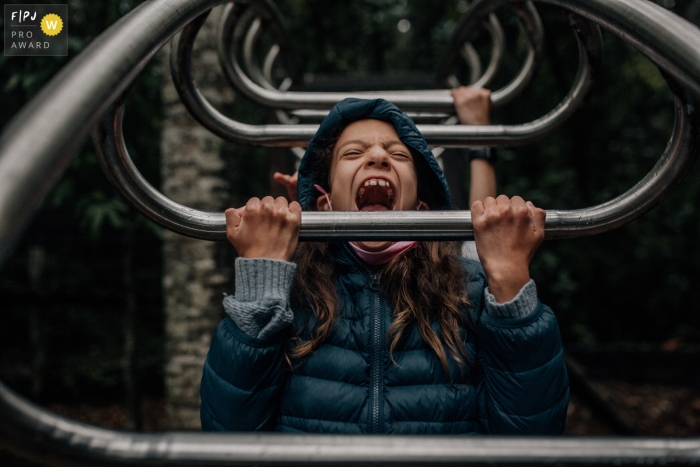 Mexico City documentary family photography shoot at the park with swinging bars and a face exhibiting Total Joy 