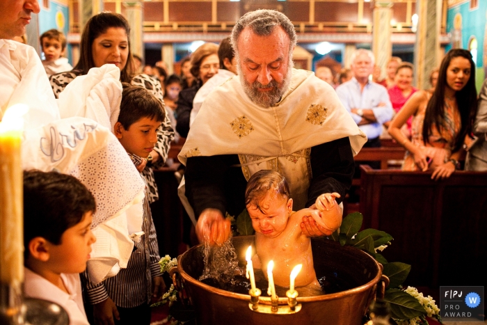 Zurich documentary family photography shoot with a baby in the water during a Greek Baptism in a church