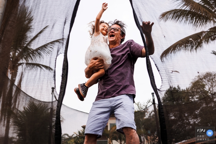 Father and daughter in a beautiful moment of surrender to fun at home on a trampoline Father and daughter in a beautiful moment of surrender to fun at home on a trampoline in Belo Horizonte, Minas Gerais