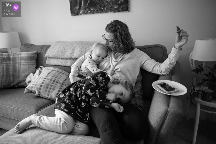 Mother with her two daughters during a family documentary session near Bristol, UK