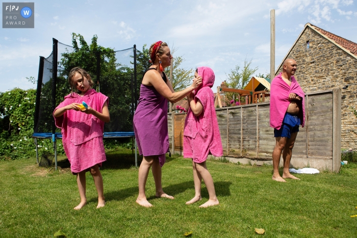 Family drying off with pink towels after a swim Family drying off with pink towels after a swim during a family documentary session near Bristol, UK