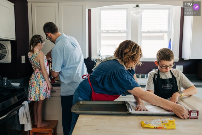 A family of four work together to prepare cookies in Madison, Wisconsin