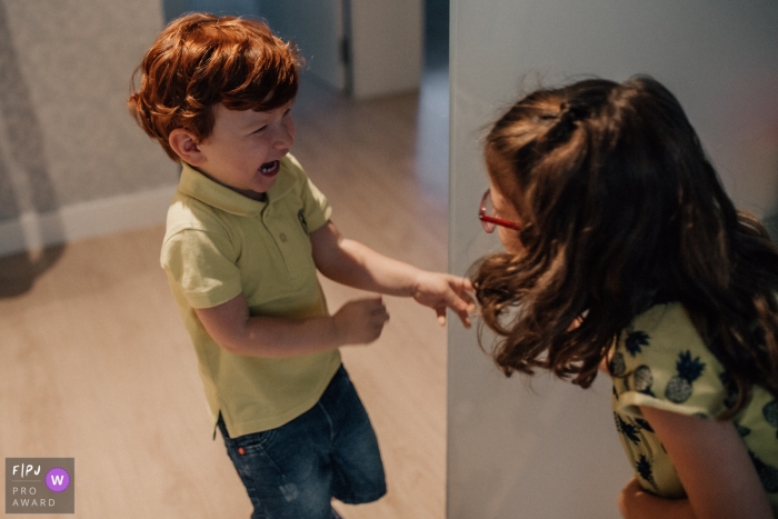Mexico City siblings play a game indoors of hide and seek to find Mexico City siblings play a game indoors of hide and seek to find