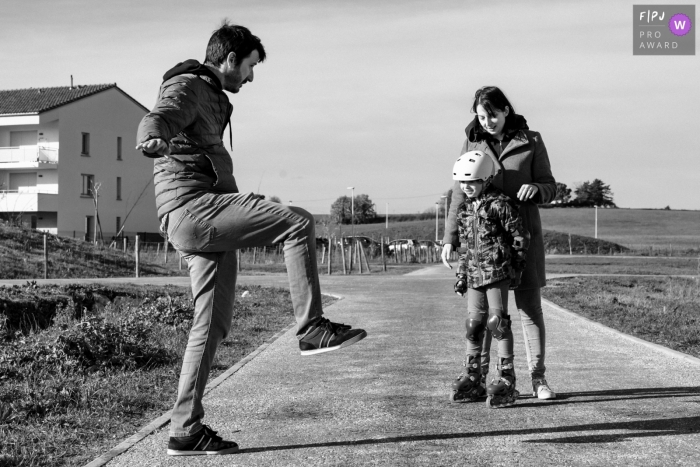 The father is teaching his daughter the art of roller skating In Paris, the dad is showing his daughter how to roller skate