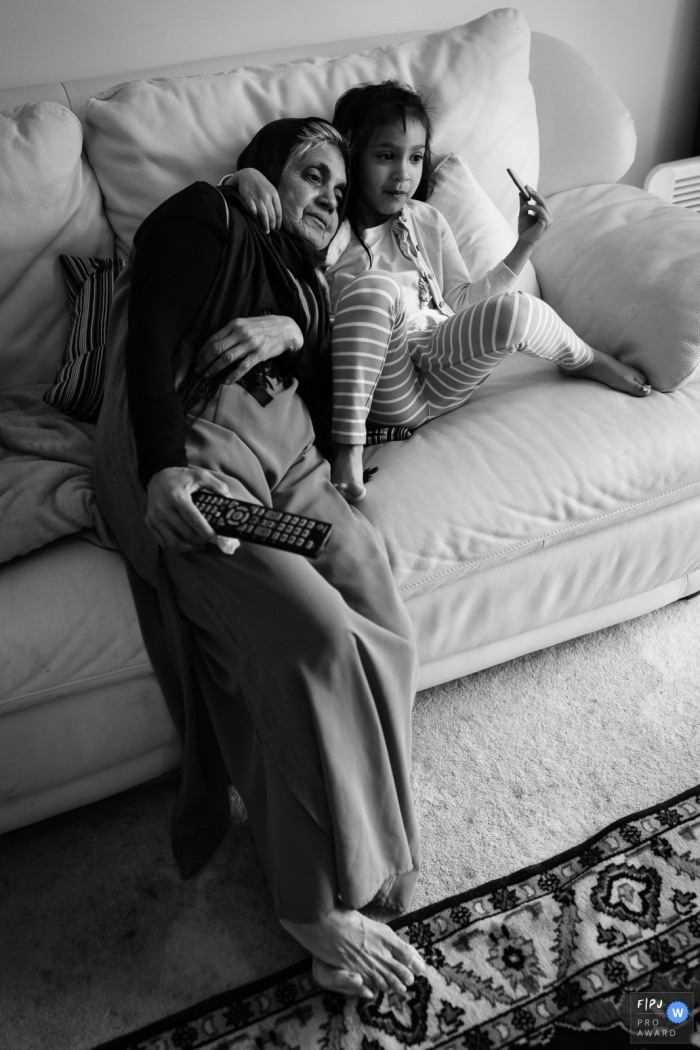 In Cambridgeshire, a girl and her grandmother bond in a cozy photo session at home A cozy photo session captures the special bond between a girl and her grandmother as they kick back and relax at home in Cambridgeshire